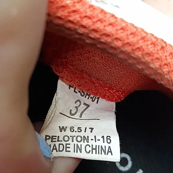 Peloton orange and white bike shoes