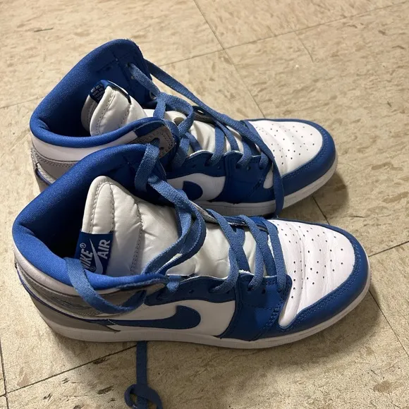 White and blue high top Nike shoes