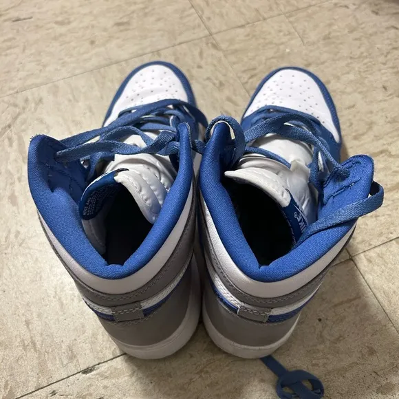 White and blue high top Nike shoes