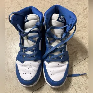 White and blue high top Nike shoes